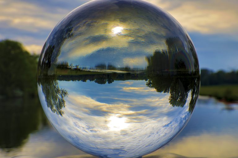 Beautiful shot of nature and lake reflection inside the glass ball