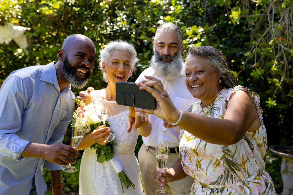 Group of friends taking selfie and celebrating with champagne outdoors. celebration, friendship, party, lifestyle, unaltered